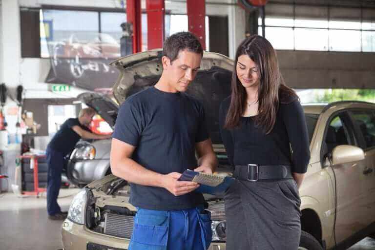 A mechanic showing a customer his clipboard