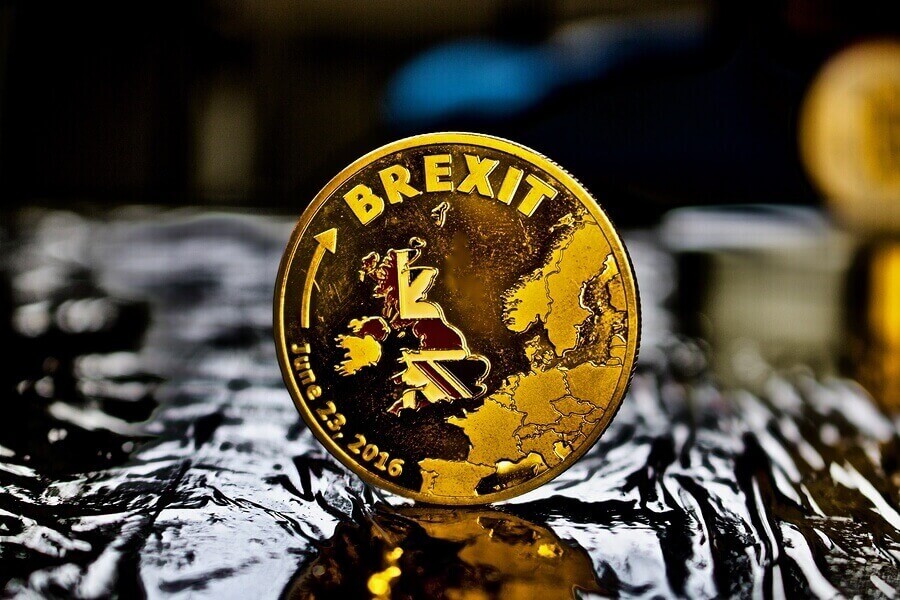 A gold coin with the UK and EU on it with Brexit across the top of the coins