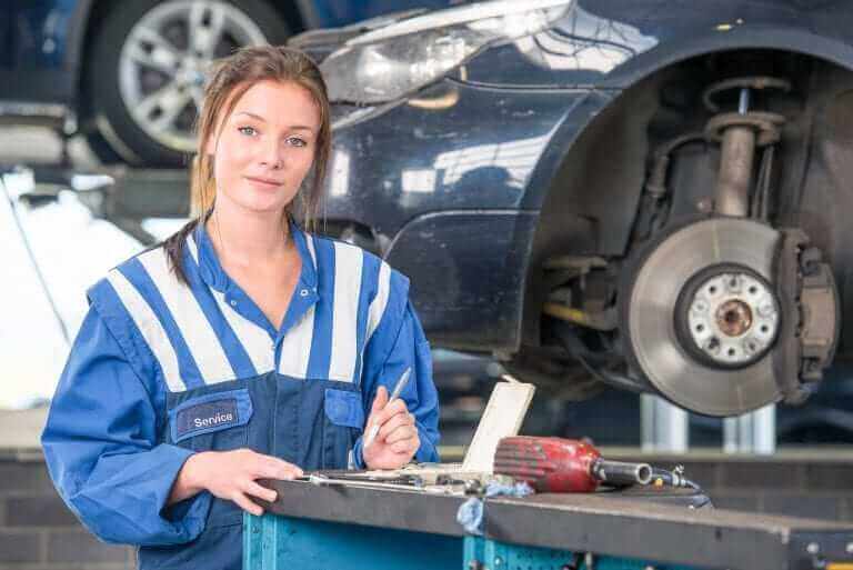 A female mechanic looking at the camera